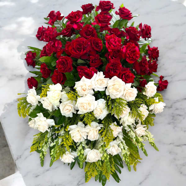 Large bouquet of red and white roses with yellow filler flowers