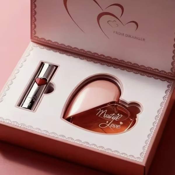 Pink gift box with a heart-shaped perfume bottle and lipstick