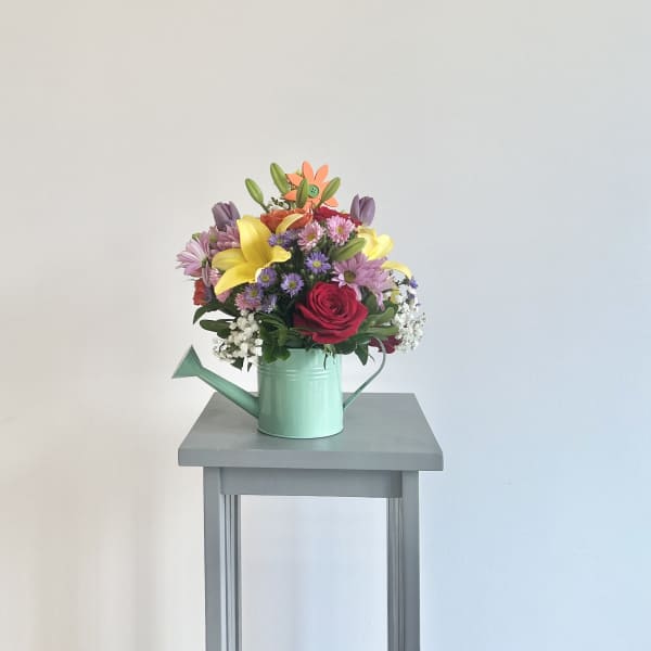 Mixed bouquet in a mint green watering can