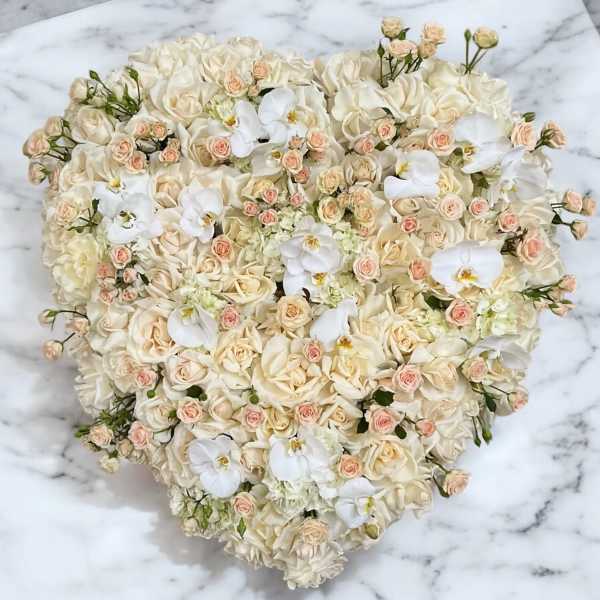 Heart-shaped bouquet of cream roses and white orchids