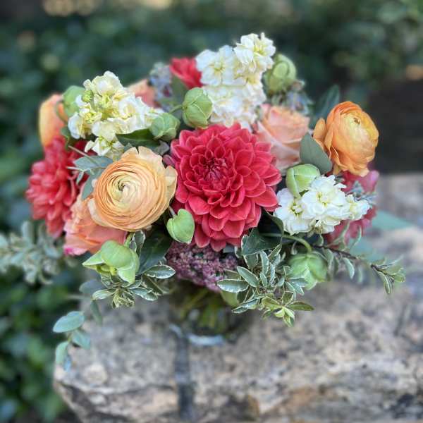 Bouquet of coral, pink, and white flowers with greenery