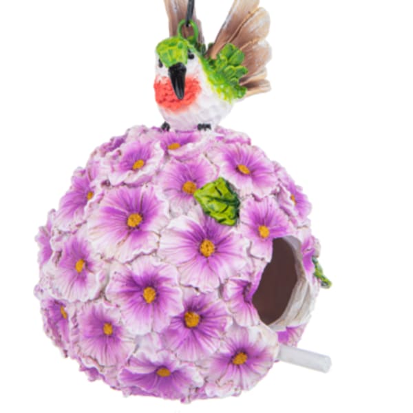 Hanging birdhouse covered in purple flowers with a small bird on top