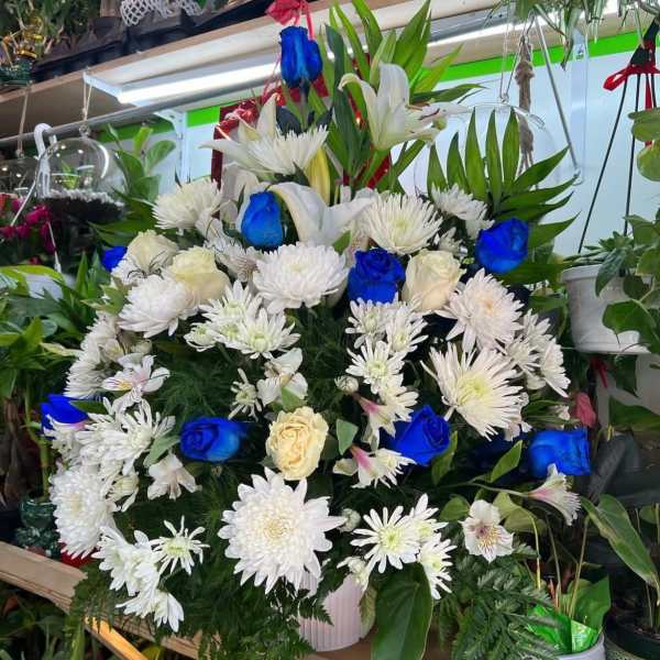 Large bouquet of white flowers with bright blue roses