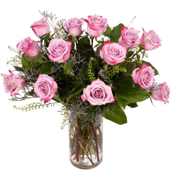 Pink roses arranged in a clear glass vase