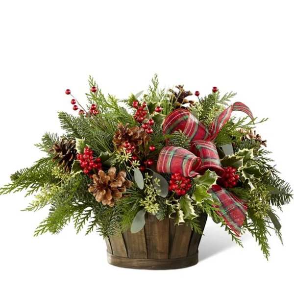 Holiday arrangement in a wooden basket with pinecones and red ribbon