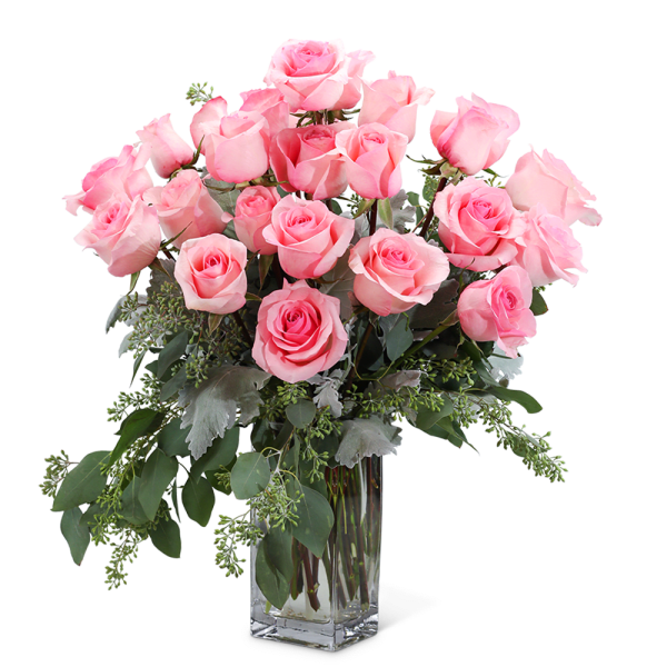 Pink roses arranged in a clear glass vase with greenery