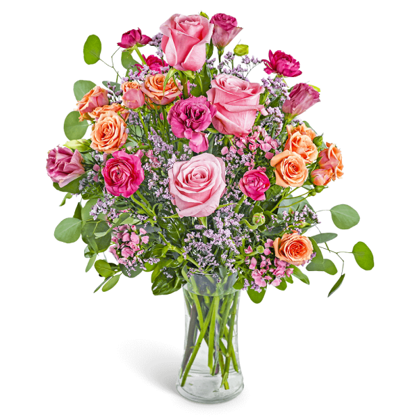 Pink and peach rose bouquet in a clear glass vase