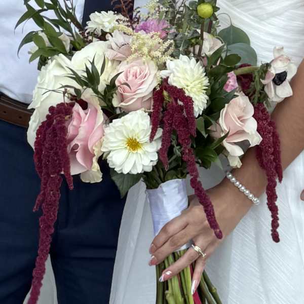 Bride holding a bouquet of pink and white flowers