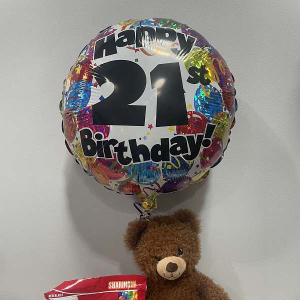 Birthday balloon with a teddy bear and a bag of Skittles candy