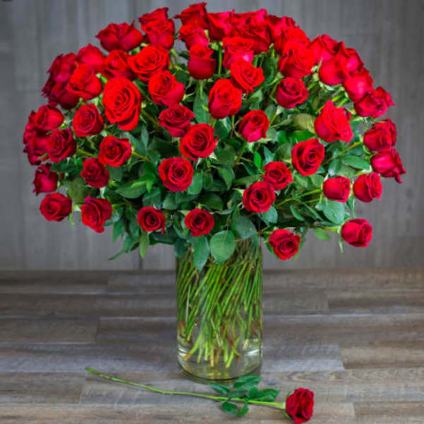 Large bouquet of red roses in a clear glass vase