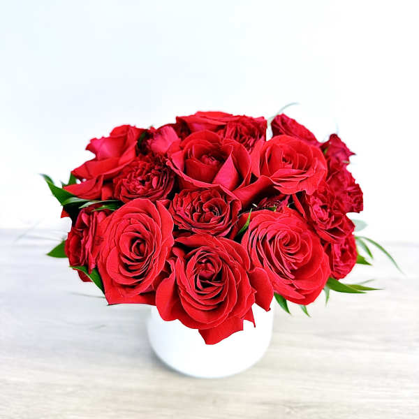 Red rose bouquet in a white vase