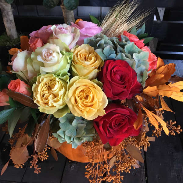 Mixed bouquet of roses in pink, yellow, red, and cream tones