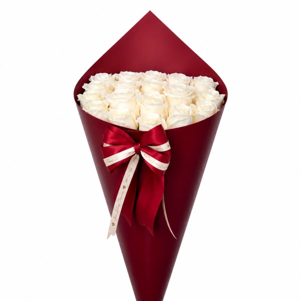 Bouquet of white roses wrapped in deep red paper with a ribbon
