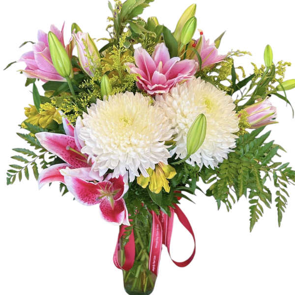 Bouquet of pink lilies and white chrysanthemums in a glass vase