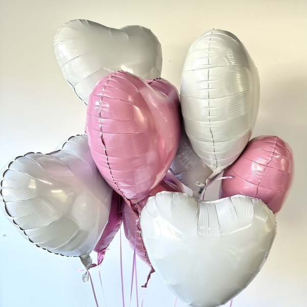 Cluster of pink and white heart-shaped balloons