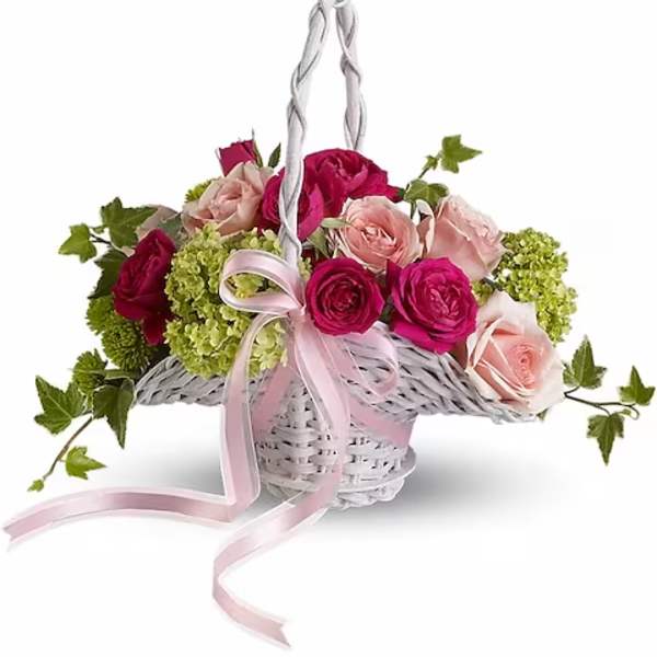 Pink and red roses in a white wicker basket with a pink ribbon