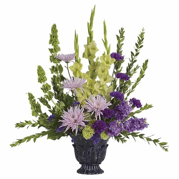 Purple and green floral arrangement in a black vase