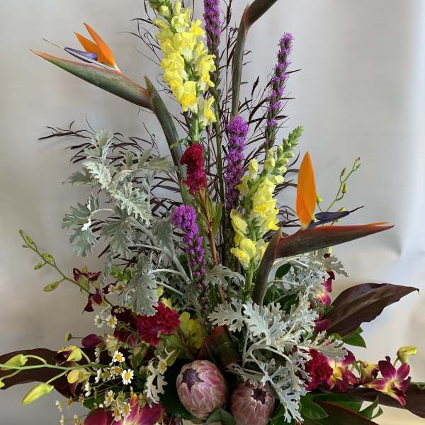 Tall tropical bouquet with orange bird-of-paradise and yellow snapdragons