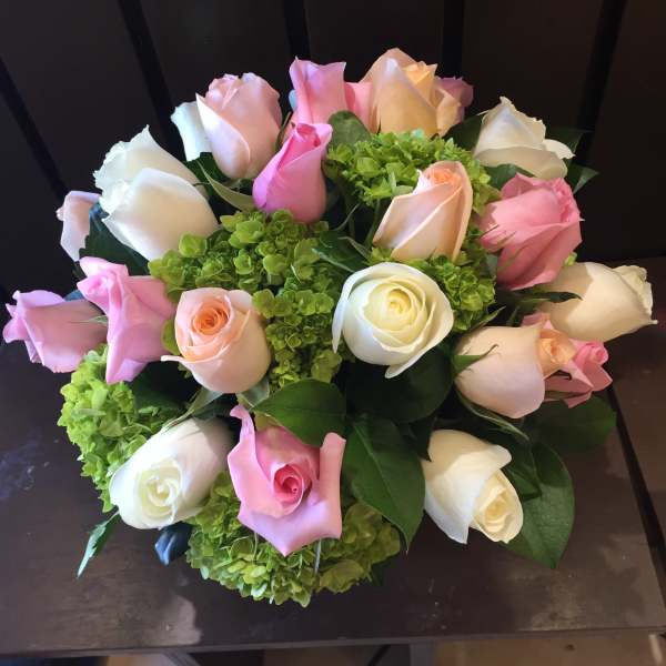 Bouquet of pink, white, and peach roses with green hydrangeas