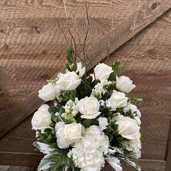 White roses and hydrangeas in a glass vase
