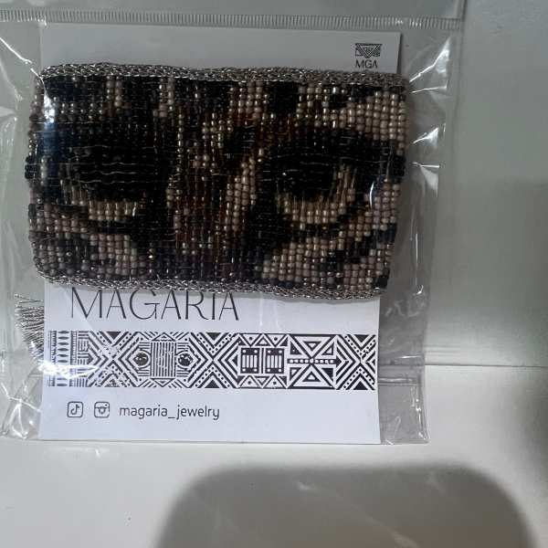 Beaded bracelet in a clear plastic package with a printed card
