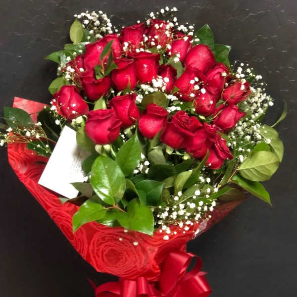 Bouquet of red roses with baby's breath and a red ribbon wrap
