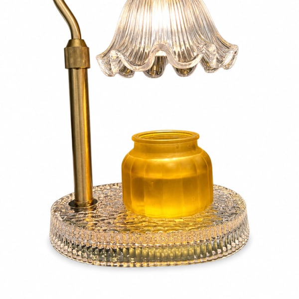 Gold-toned lamp with a clear ribbed glass shade and yellow glass base