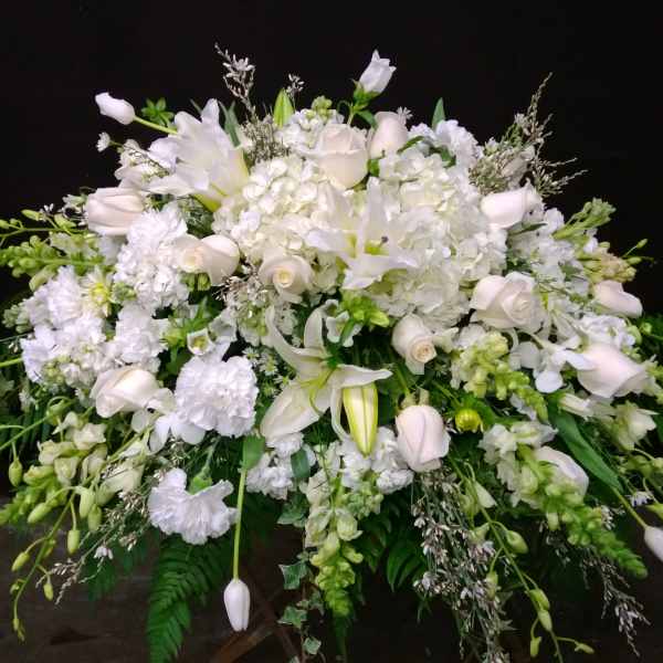 White floral spray with lilies, roses, and hydrangeas