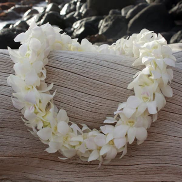 White flower lei on a wooden surface