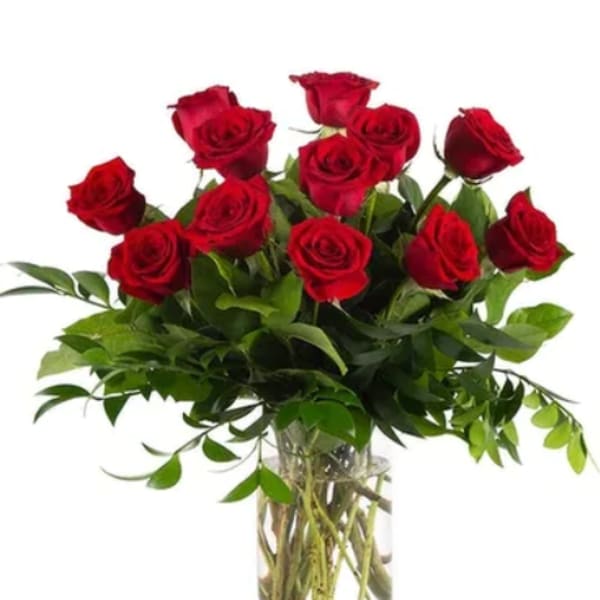 Red roses arranged in a clear glass vase