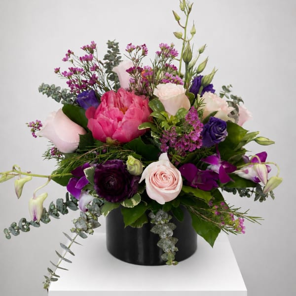 Pink and purple mixed bouquet in a black vase
