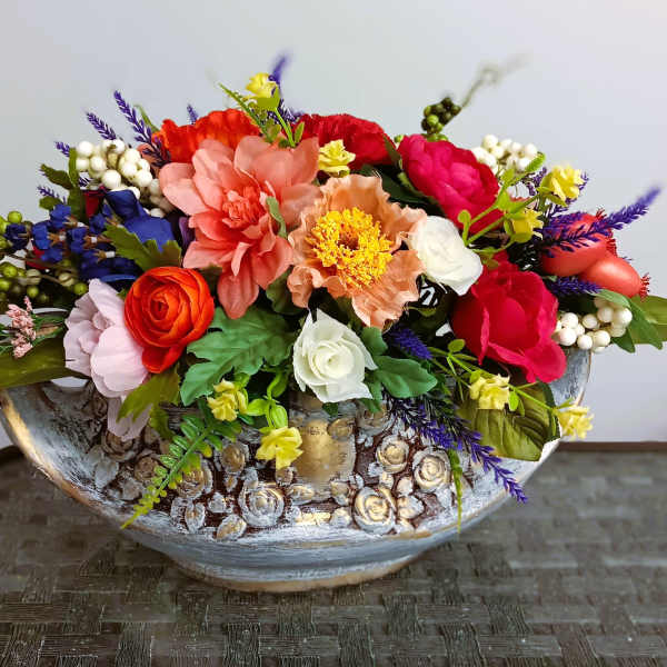 Colorful mixed flower arrangement in a decorative ceramic bowl
