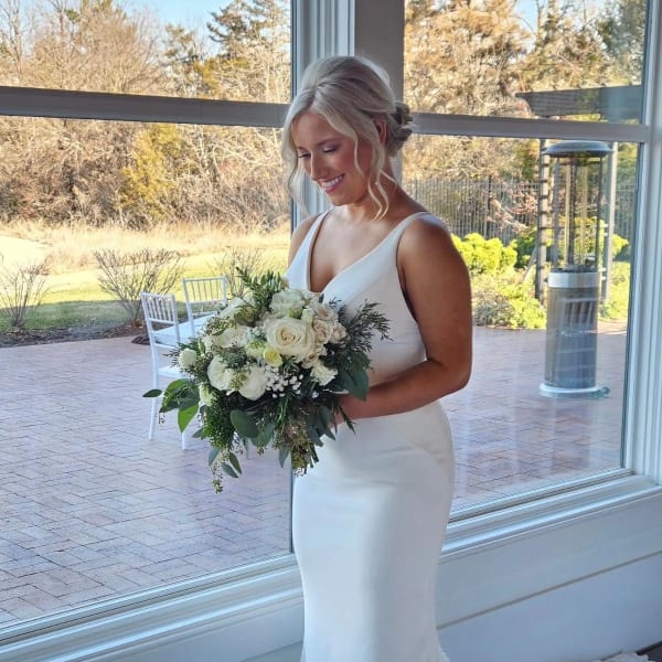 Bride holding a white and green bouquet