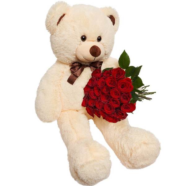 Cream teddy bear holding a bouquet of red roses