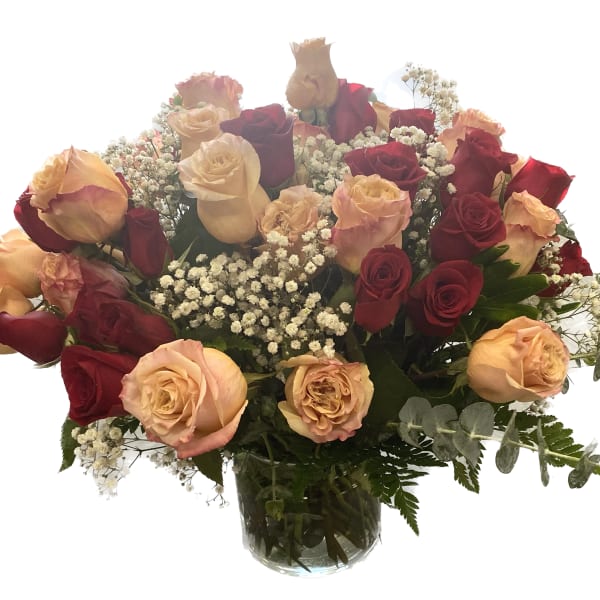 Bouquet of red and peach roses in a clear glass vase