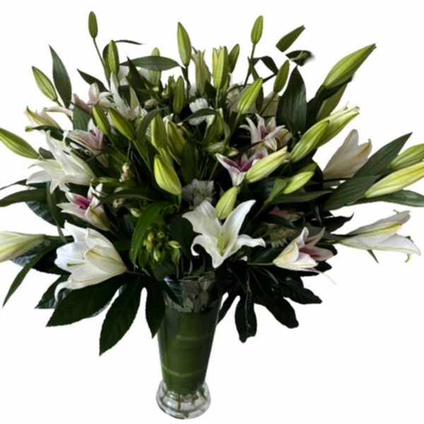 Bouquet of white lilies in a glass vase