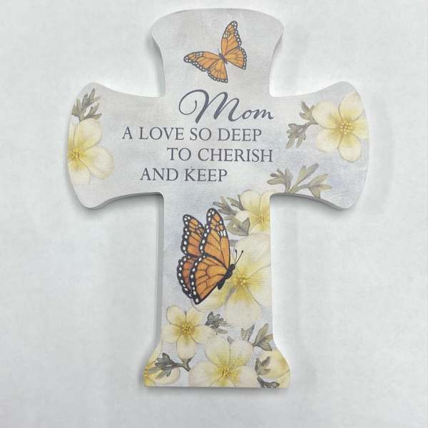 Cross-shaped memorial plaque with butterflies and flowers reading "Mom"