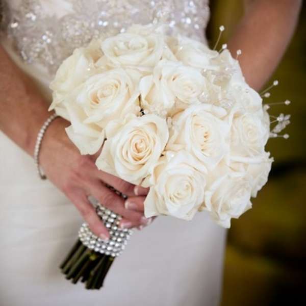 Bride holding a bouquet of white roses