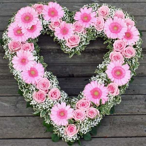 Heart-shaped floral wreath with pink gerbera daisies and roses