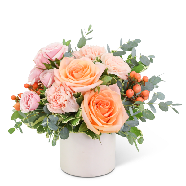 Pink and peach roses in a white vase