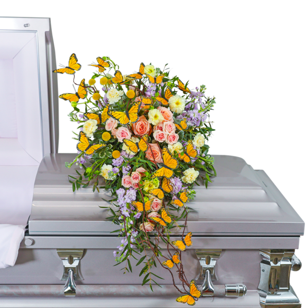 Floral casket spray with pink roses, lavender flowers, and orange butterflies