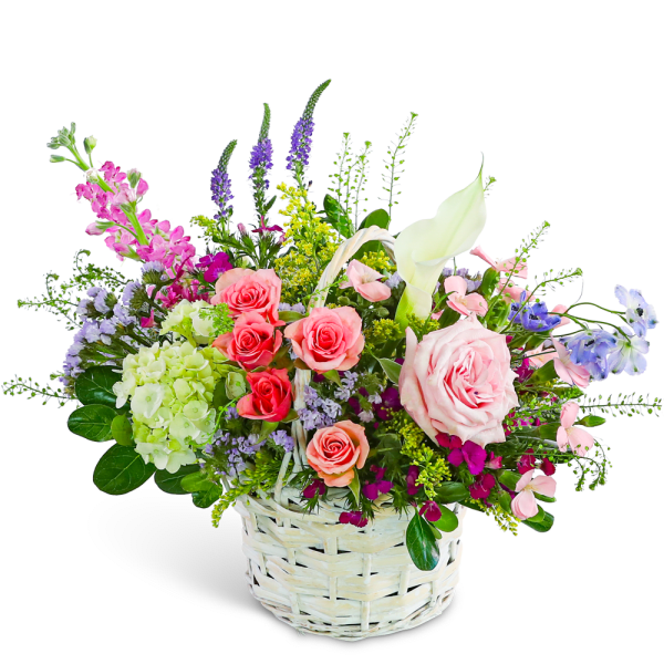 Mixed bouquet in a white wicker basket with pink roses and a white calla lily