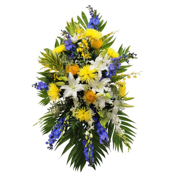 Tall floral spray with white lilies, yellow blooms, and blue flowers