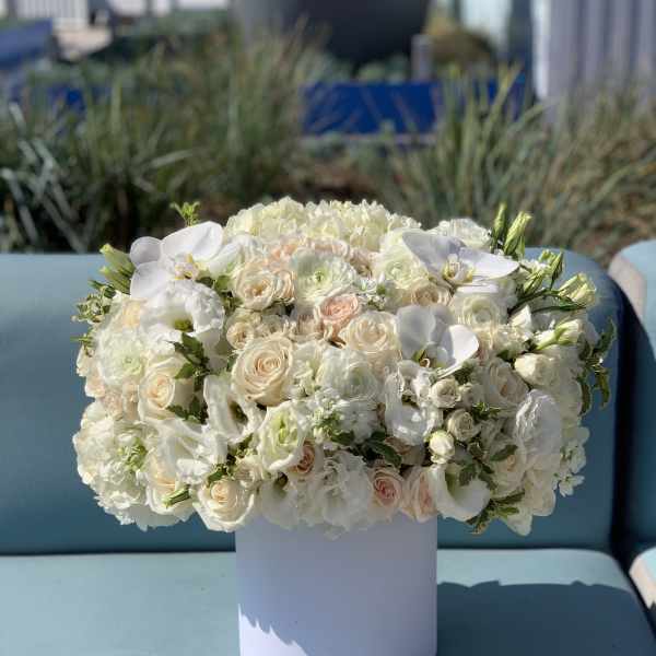White floral arrangement in a round white vase