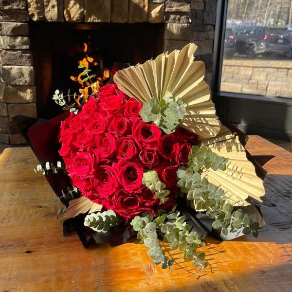 Red rose bouquet with eucalyptus and gold fan accents