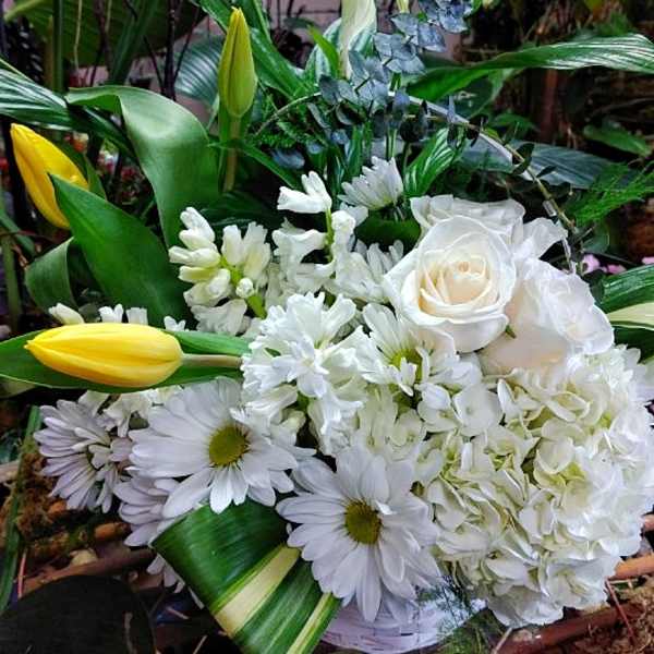 White bouquet with roses, daisies, and yellow tulips