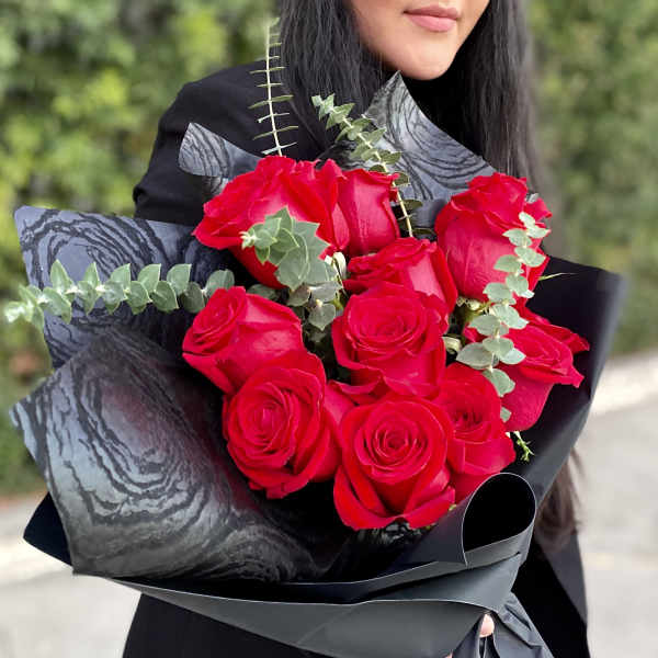 Bouquet of red roses wrapped in black paper