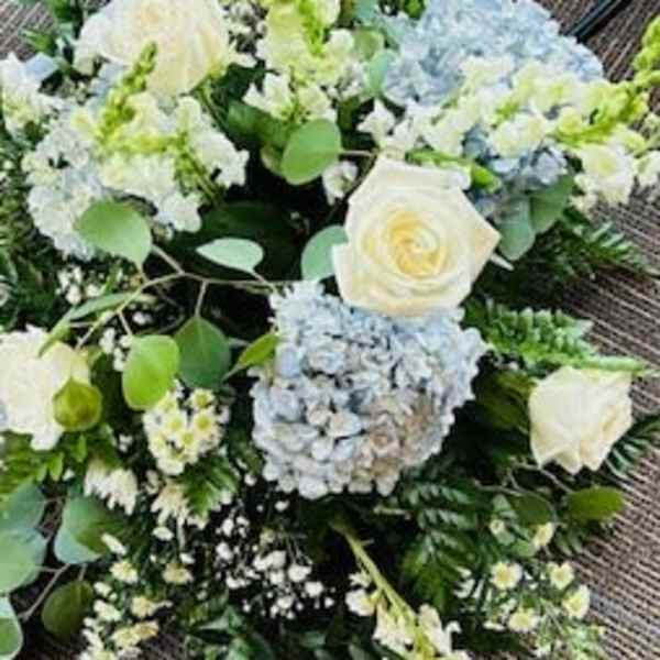 White and pale blue wedding bouquet with roses and hydrangeas