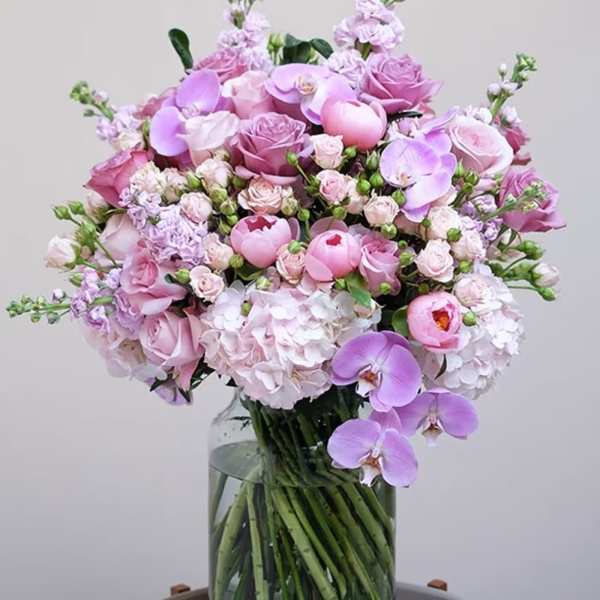 Pink and lavender bouquet in a clear glass vase