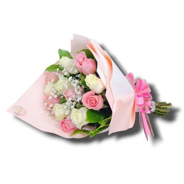 Hand-tied bouquet of pink and white roses with baby's breath wrapped in pink paper and ribbon.